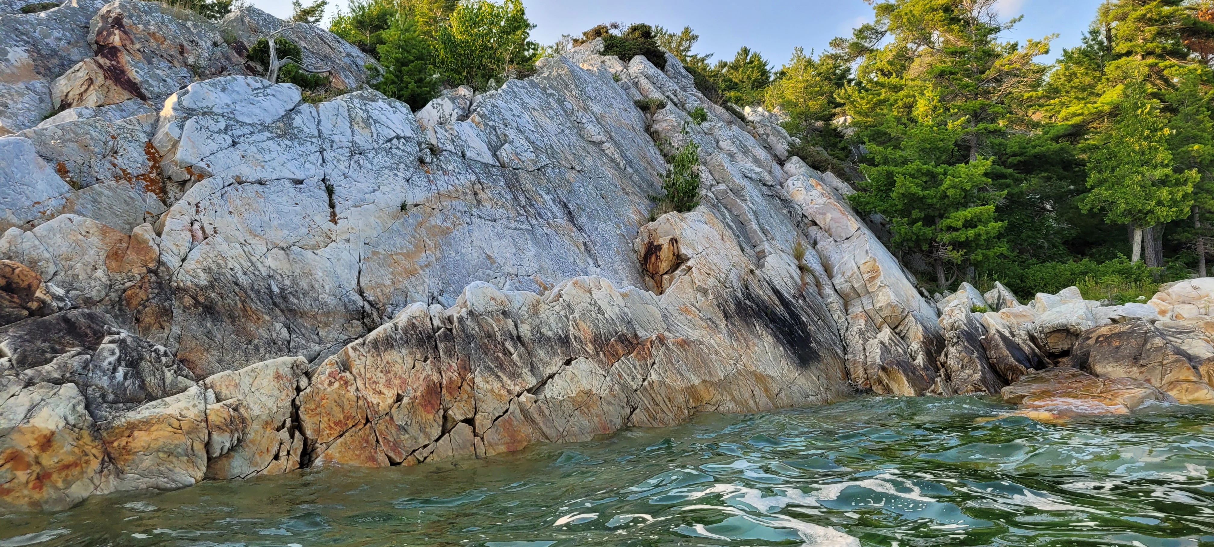 White quartzite cliffs and windswept pine trees in Killarney Bay